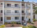 Multi-story condo building with private balconies and well-maintained landscaping at 1156 Bird Bay Way # 104, Venice, FL 34285