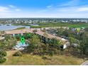 Overhead view featuring community pool, lush landscaping and nearby waterways at 1190 Bird Bay Way # 309, Venice, FL 34285