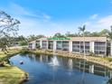 Waterfront condo has screened in patios and a fountain in the pond at 1190 Bird Bay Way # 309, Venice, FL 34285