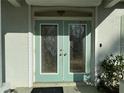 Close-up of elegant glass double doors, offering a grand entrance and enhanced curb appeal at 1483 Prairie Ter, North Port, FL 34286