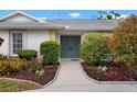 Inviting front entrance with a double door entry, mature landscaping and a well maintained walkway at 1833 Raintree Ln, Venice, FL 34293