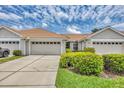 Exterior view of home's garage, landscaping, and driveway on a sunny day at 1892 San Silvestro Dr, Venice, FL 34285