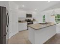 Modern kitchen boasts stainless steel appliances, a functional island, and an abundance of cabinet space at 2032 Jagust Rd, North Port, FL 34288