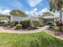 Beautiful home exterior featuring manicured landscaping, a walkway, and a cozy bench, offering a welcoming entrance at 232 Cerromar Way # 38, Venice, FL 34293