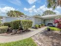 Inviting home entrance with a tidy walkway, garden, and decorative pots, showcasing great curb appeal at 232 Cerromar Way # 38, Venice, FL 34293