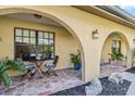 Inviting covered patio with arched entryways, cozy seating, and decorative plants at 236 Cory St, Port Charlotte, FL 33953