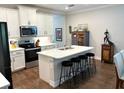Spacious kitchen with a center island, seating, and stainless steel appliances at 236 Soliera St, Nokomis, FL 34275