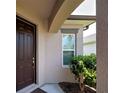 Inviting front entrance with a well-kept lawn and colorful plants at 25784 Grayton Ave, Englewood, FL 34223
