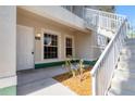 Close up of front of condo with white door, small garden area, and stairwell on right at 2614 River Preserve Ct # 2614, Bradenton, FL 34208