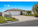 Inviting single-story home showcasing a well-manicured lawn, mature landscaping, and a welcoming entrance with ample driveway space at 270 Capri Ave, Venice, FL 34293