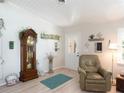 Comfortable room features a grandfather clock, soft chair, and ample natural light at 30 Jamestown Ave, Englewood, FL 34223