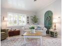 Cozy living room with a white sofa, shuttered windows, and charming decor at 30 Jamestown Ave, Englewood, FL 34223