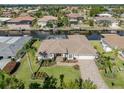 Aerial view of a waterfront property featuring a well-manicured lawn, and beautiful landscaping at 314 Oakwood Cir, Englewood, FL 34223