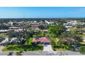An aerial view showcasing a neighborhood with lush greenery and beautiful single-Gathering homes at 316 Signorelli Dr, Nokomis, FL 34275