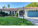 Close up shot of a charming home featuring a brick driveway, front lawn, and well-kept landscaping at 316 Signorelli Dr, Nokomis, FL 34275