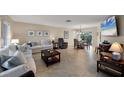 Bright living room featuring tile floors, a dining area, comfortable seating, and lots of natural light at 316 Signorelli Dr, Nokomis, FL 34275