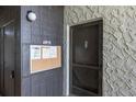 Hallway view of unit entry door with a bulletin board and a 'No Smoking' sign at 3255 Beneva Rd # 102, Sarasota, FL 34232