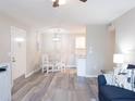Open-concept living area with dining table, gray flooring, and neutral color scheme at 3255 Beneva Rd # 102, Sarasota, FL 34232