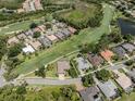 An aerial view of a beautiful residential neighborhood with mature trees and lush landscaping, with the home outlined in white at 396 Lansbrook Dr, Venice, FL 34292