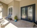 Inviting front porch featuring a decorative glass front door, transom window, and elegant light-colored brickwork at 396 Lansbrook Dr, Venice, FL 34292