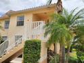 Charming two-story condo with stairs and lush landscaping, offering a welcoming entrance at 4244 Vicenza Dr # D34, Venice, FL 34293