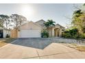 Charming one-story house features an attached garage, well-maintained landscaping, and a palm tree in the front yard at 429 Riviera St, Venice, FL 34285