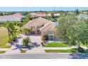 Single-Gathering home with palm trees, lake view, arched entryway, and tile roof at 4403 Via Del Villetti Dr, Venice, FL 34293