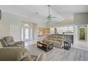 Comfortable living room with tile and wood flooring, neutral decor, and a view into the dining area at 447 Rotonda Cir, Rotonda West, FL 33947
