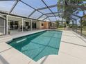 Sparkling screened-in pool with a spacious patio area perfect for outdoor entertaining at 455 Rubens E Dr, Nokomis, FL 34275
