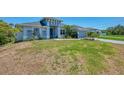 Charming house with lush green grass and beautiful landscaping adding to its curb appeal at 4624 Caribou Ave, North Port, FL 34287