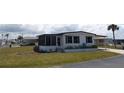 Well-maintained single-story home with a screened-in porch, offering comfortable outdoor living space and curb appeal at 542 Walnut Cir, Venice, FL 34285