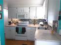 Bright kitchen featuring white cabinets, modern appliances, and stylish backsplash, perfect for cooking and entertaining at 542 Walnut Cir, Venice, FL 34285