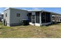 Single-story house features a screened-in porch and neat lawn at 5668 Holiday Park Blvd, North Port, FL 34287
