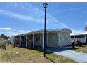 Inviting single-story home with a covered parking area and manicured landscaping at 5668 Holiday Park Blvd, North Port, FL 34287