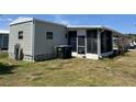 Single-story house features a screened-in porch and neat lawn at 5668 Holiday Park Blvd, North Port, FL 34287