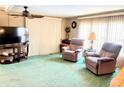 Bright living room with comfortable recliners, a ceiling fan, and neutral decor offers relaxation at 603 Leisure, Venice, FL 34285
