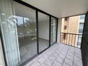 Balcony featuring sliding glass doors and tiled flooring with an outdoor view at 618 Bird Bay S Dr # 212, Venice, FL 34285