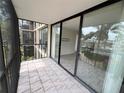 Balcony featuring sliding glass doors and tile floor with screened enclosure at 618 Bird Bay S Dr # 212, Venice, FL 34285