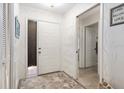 Bright entryway with patterned wallpaper, decorative rug, and access to multiple rooms at 657 Foxwood Blvd, Englewood, FL 34223