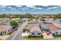 An aerial view of a single-story home located in a charming neighborhood with well-maintained streets at 710 Ironwood Dr # 165, Venice, FL 34292