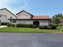 Exterior of clubhouse with beautiful landscaping on a sunny day at 744 Avenida Estancia # 142, Venice, FL 34292