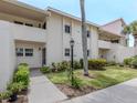 Inviting condo exterior featuring well-manicured landscaping and a welcoming entrance at 758 Village Cir # 106, Venice, FL 34292