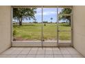 Screened-in lanai showcasing serene views of the meticulously kept lawn at 758 Village Cir # 106, Venice, FL 34292