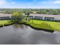 Wonderful back exterior of condo complex with stunning lake views and lush landscaping at 821 Waterside Dr # 205, Venice, FL 34285
