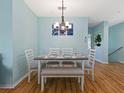 Dining area with table, chairs and bench with view to a house plant, and stairway at 904 Addington Ct # 204, Venice, FL 34293
