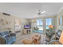 Cozy living room with a view to the beach and glimpses into the bedroom at 950 Tarpon Center Dr # 504, Venice, FL 34285