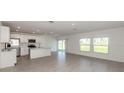 Bright, open-concept living area features white cabinets, stainless steel appliances, tile flooring, and natural light at 11228 Fieldstone Dr, Palmetto, FL 34221
