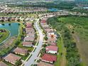 Beautiful aerial view of a residential community with lakes, green spaces and tile roofs at 12728 Richezza Dr, Venice, FL 34293