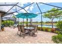 Charming screened-in patio with a dining set perfect for enjoying meals outdoors with a scenic water view at 13873 Karina St, Venice, FL 34293