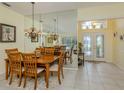 Bright dining room with a large mirror, chandelier and elegant furnishings at 143 Braemar Ave, Venice, FL 34293